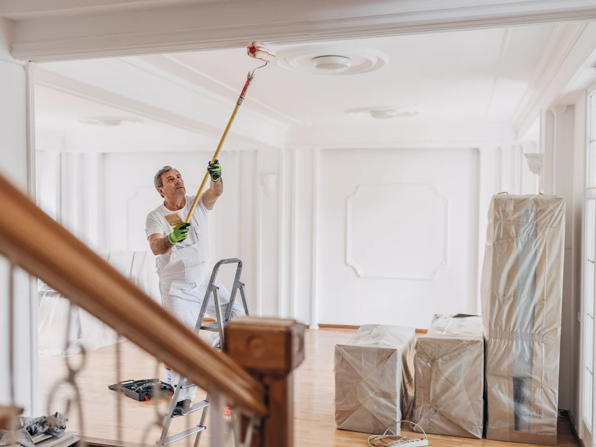Ceiling painting in Bath by Bath Decorators, painter applying white paint to ceiling