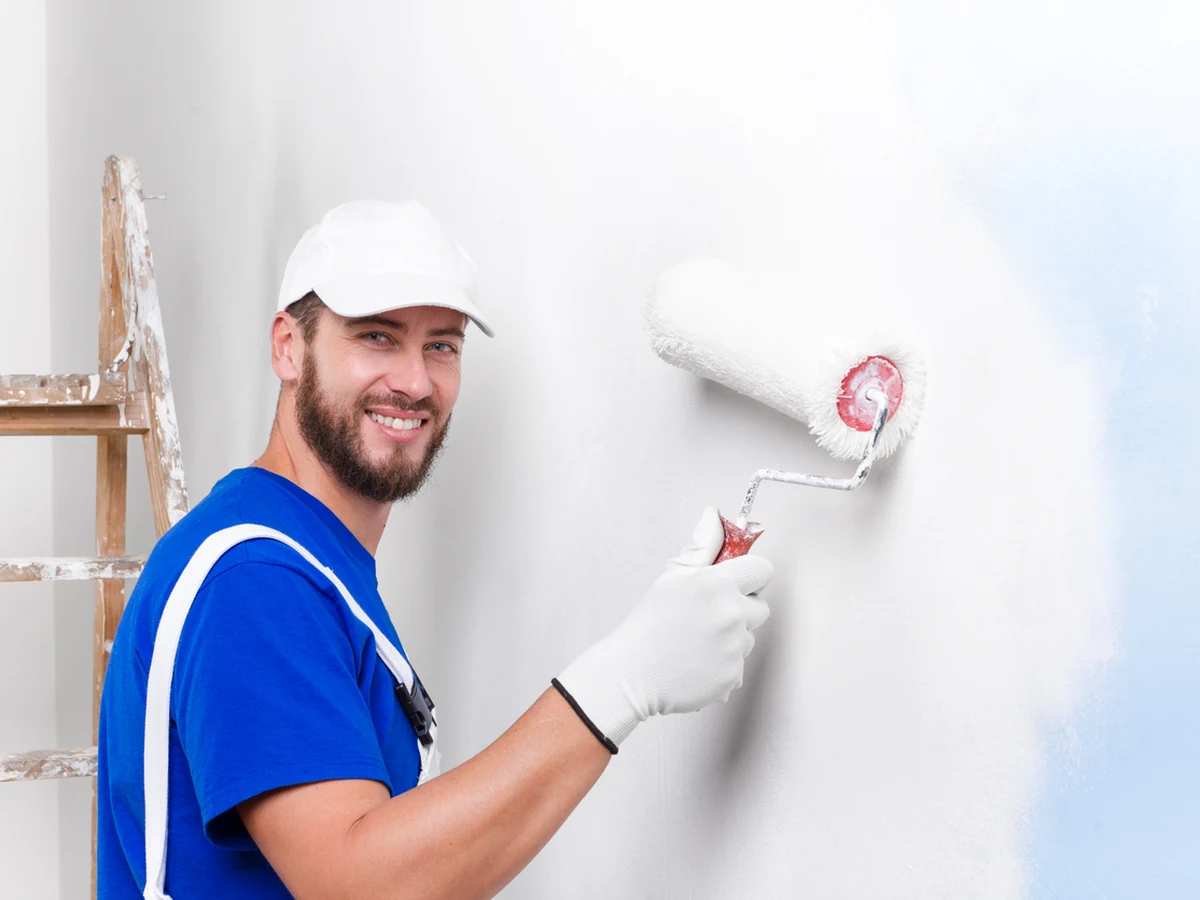 Bath Decorators painter smiling in blue overalls, professional bathroom refresh service in Bath