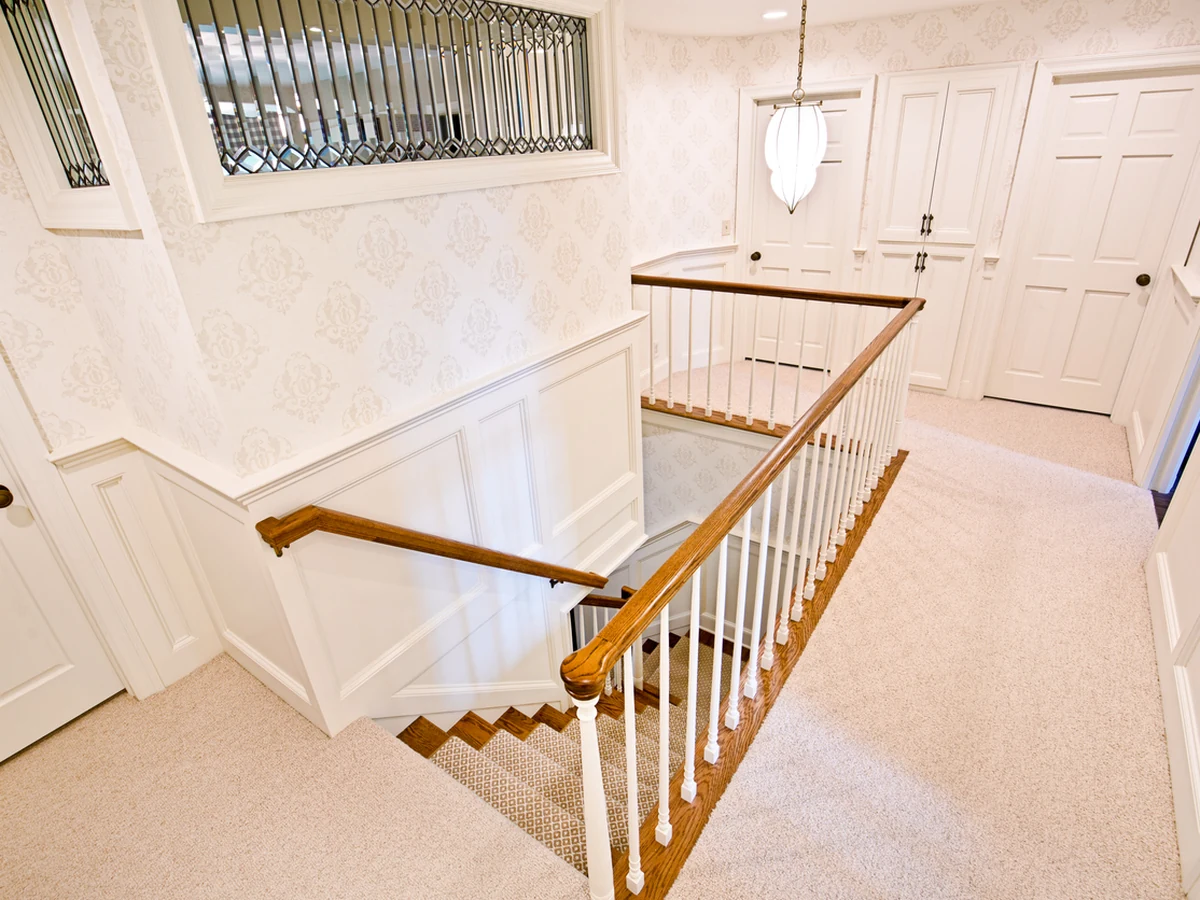 Elegant white banister staircase painting in Bath by Bath Decorators